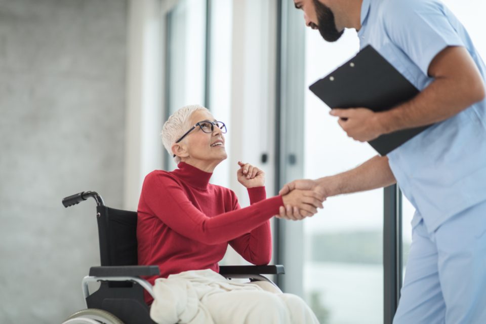 A caregiver greeting a senior woman during an in-home consultation